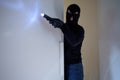 Burglar wearing a balaclava holding flashlight Royalty Free Stock Photo