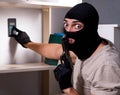 Burglar wearing balaclava mask at crime scene Royalty Free Stock Photo