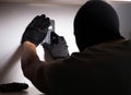 Burglar wearing balaclava mask at crime scene Royalty Free Stock Photo