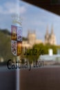 BURGOS, SPAIN - April 9, 2021: Reflection of the Cathedral of Burgos in a glass with the logo of the Junta de Castilla y Leon in