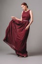 Burgundy chic gown. Red cocktail sleeveless dress with rounded neckline and flying effortless skirt