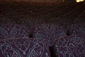 Burgundy colored seats with an ornate pattern in an old theater