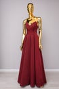 Burgundy fashion long dress on gold mannequin