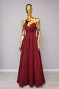 Burgundy fashion long dress on gold mannequin