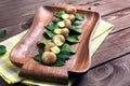 Burgundy snail on a wooden tray Royalty Free Stock Photo