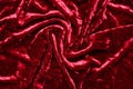 Burgundy velvet fabric, folds. Texture