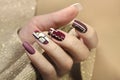 Burgundy and white design on long nails