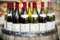 Burgundy wine bottles over a barrel