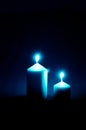 Burial concept with two burning candles against black background Royalty Free Stock Photo