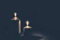 Burial concept with two golden burning candles against black background Royalty Free Stock Photo