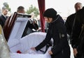 Burial service, relatives giving their last farewell to a late, cemetery Royalty Free Stock Photo