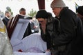 Burial service, relatives giving their last farewell to a late, cemetery Royalty Free Stock Photo