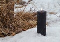 Buring black candle in snow, magic ritual