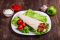 Burito with meat. Fried pork, beef, tomatoes
