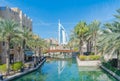 Burj Al Arab Jumeirah Island or boat building with turquoise lake or river and reflection, Dubai Downtown skyline, United Arab Royalty Free Stock Photo