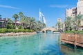 Burj Al Arab Jumeirah Island or boat building with turquoise lake or river and reflection, Dubai Downtown skyline, United Arab Royalty Free Stock Photo