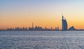 Burj Al Arab in Jumeirah Island or boat building with waves on sea beach, Dubai Downtown skyline, United Arab Emirates or UAE. Royalty Free Stock Photo