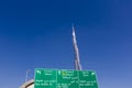 Burj Khalifa with directional sign and clear blue sky in Dubai