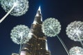 Burj Khalifa in the night against of luminous dandelions. Royalty Free Stock Photo