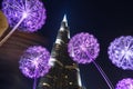 Burj Khalifa in the night against of luminous dandelions. Royalty Free Stock Photo