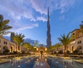 Burj Khalifa and palm trees in Palace Downtown, Dubai skyline, United Arab Emirates or UAE. Financial district and business area