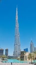 Burj Khalifa world`s tallest tower against a deep blue sky background in Dubai, United Arab Emirates with reflective pond in front