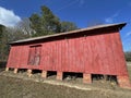 Old creepy abandoned building in rural Georgia red barn on bricks side Royalty Free Stock Photo