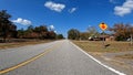 POV driving country road blue sky fall season stop sign warning Royalty Free Stock Photo