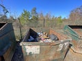 A rural county public waste trash dump for local residents contents of a dumpster