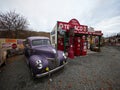 Burkes Pass, New Zealand - 2023: Violet purple Ford classic car with Texaco historic antique gas station outdoor museum Royalty Free Stock Photo