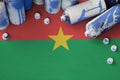 Burkina Faso flag and few used aerosol spray cans for graffiti painting. Street art culture concept