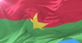 Burkina Faso flag waving at wind in slow with blue sky, loop