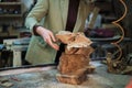 Burl wood, known for its complex grain patterns, is sorted with precision, as a craftsman prepares for the delicate Royalty Free Stock Photo