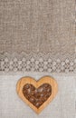 Burlap background with lacy cloth and wooden heart Royalty Free Stock Photo