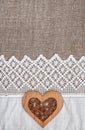 Burlap background with lacy cloth and wooden heart Royalty Free Stock Photo