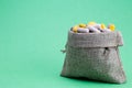 Burlap bag full of drug and medicine pills.grren background pharmaceutical cost concept. medications in the cart. buying medicines Royalty Free Stock Photo