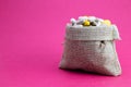 Burlap bag full of drug and medicine pills. Paid medicine. Purchase of medicines pink background. Medicine and pharmacy concept Royalty Free Stock Photo