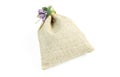 Burlap bag with lavender flower isolated on white background. Brown pouch