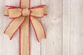 Burlap Christmas bow and ribbon side border on old white wood Royalty Free Stock Photo