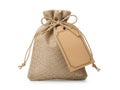 Burlap gift bag with tag isolated on white background Royalty Free Stock Photo