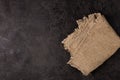 Burlap napkin on a dark structural background, top view Royalty Free Stock Photo