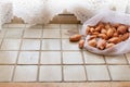 Burlap sack bags with shallot onions from local market, view from above and  on light tiles Royalty Free Stock Photo