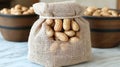 A burlap sack overflowing with peanuts on a light blue surface with additional peanut bowls in the background Royalty Free Stock Photo