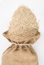 Burlap sack with pearl barley spilling out over a Royalty Free Stock Photo