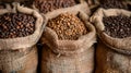 Burlap sacks filled with different types of coffee beans Royalty Free Stock Photo
