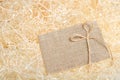 Burlap tag on straw background. Royalty Free Stock Photo
