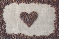 Burlap texture with coffee beans heart shape Royalty Free Stock Photo