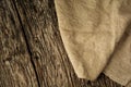 Burlap texture on rustic wooden table background. Free space for text. Flat lay Royalty Free Stock Photo