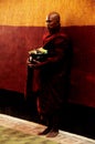 Burma monk standing in Ananda paya temple for receive donate from burmese people and foreign traveler travel visit respect praying