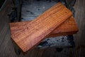 Burma padauk wood has tiger stripe or curly stripe grain on the table at blurred background